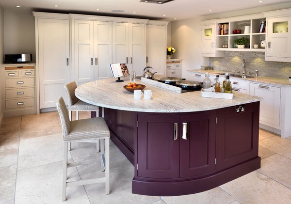 Customized kitchen island with variable depth cabinets and comfortable seating arrangement