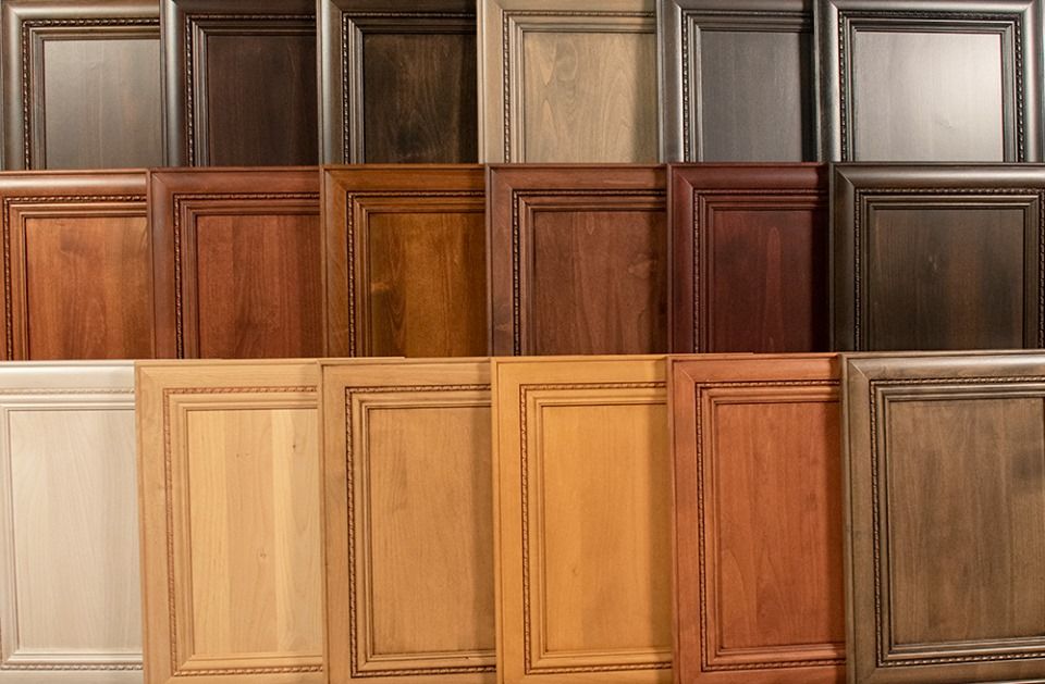 Various finish options on industrial wood cabinets, including raw, stained, and high-gloss, showcasing versatile design possibilities