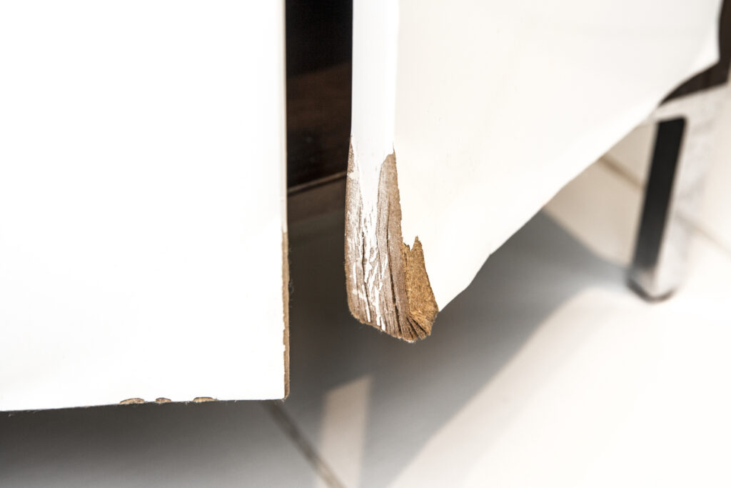 An MDF panel showing signs of moisture damage, illustrating a limitation of MDF cabinets in high-humidity environments